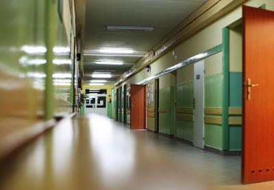 Open doors in a poorly-lit hallway at school after hours