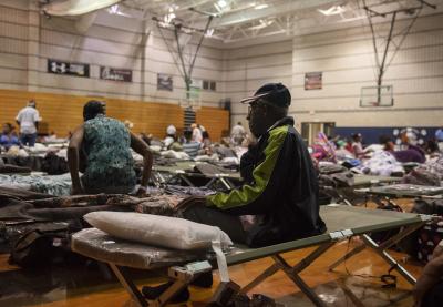 A resident sits on a cot at an evacuation shelter ahead of Hurricane Florence at the Southeast Raleigh High School in Raleigh, North Carolina, U.S., on Wednesday, Sept. 12, 2018.