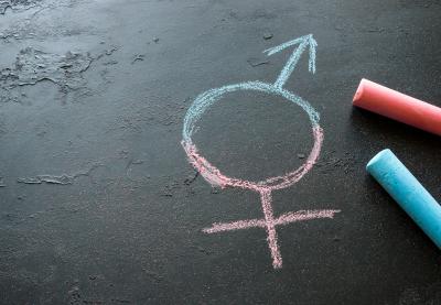 Fused male and female symbol drawn with chalk on a blackboard.