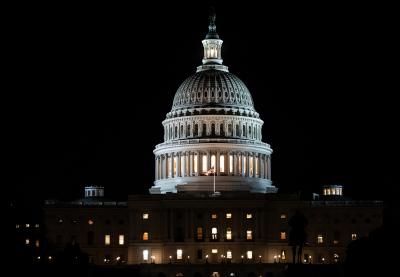 The United States Capitol building illuminated at night.