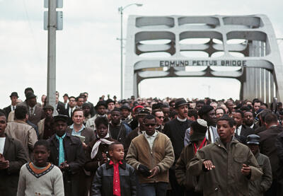 Civil Rights Movement activists marching over the Edmund Pettus Bridge.