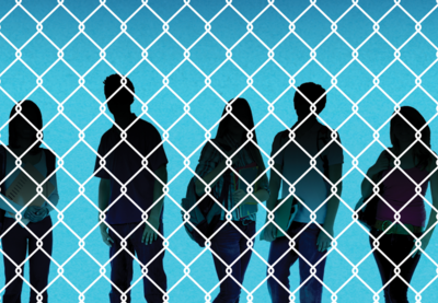 Silhouettes of children behind a chainlink fence.