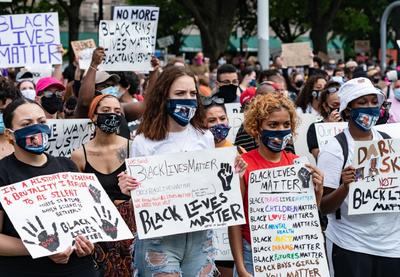 Protesters carrying signs that emphasize "Black Lives Matter."