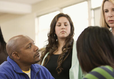 A group of educators speaking to each other.