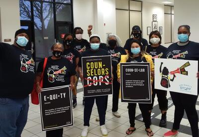 Group of people holding signs.