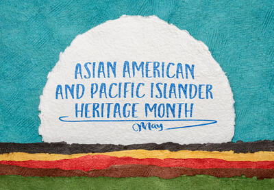 Asian American and Pacific Islander Heritage Month text on blue and white background with brown, red, yellow and green horizontal lines across the bottom.