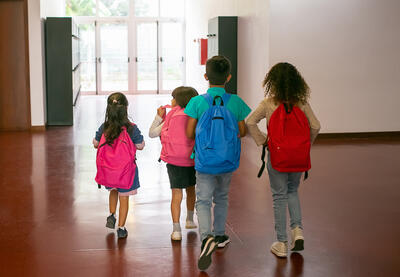 Diverse children walking in school 