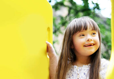 Smiling girl on yellow play set