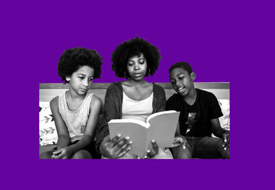 Adult woman and two children reading and discussing