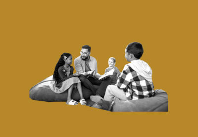 Adult and group of children talking