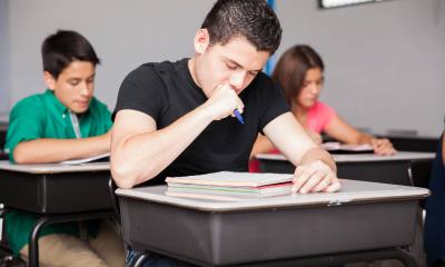 male student working at his desk