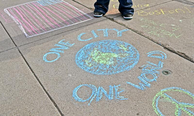 Sidewalk chalk reading one city one world