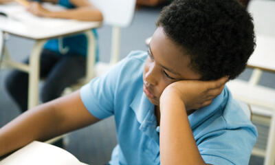 boy reflecting at desk