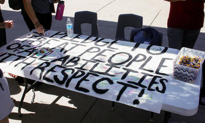 handmade sign reads I pledge to treat people of all abilities with respect