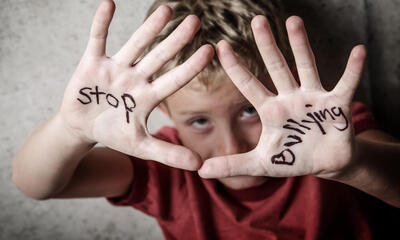 Student with stop bullying written on hands