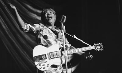 Sister Rosetta Tharpe singing in front of a microphone.