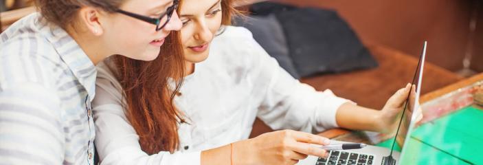 girls looking at computer