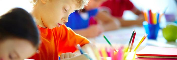 boy coloring at table