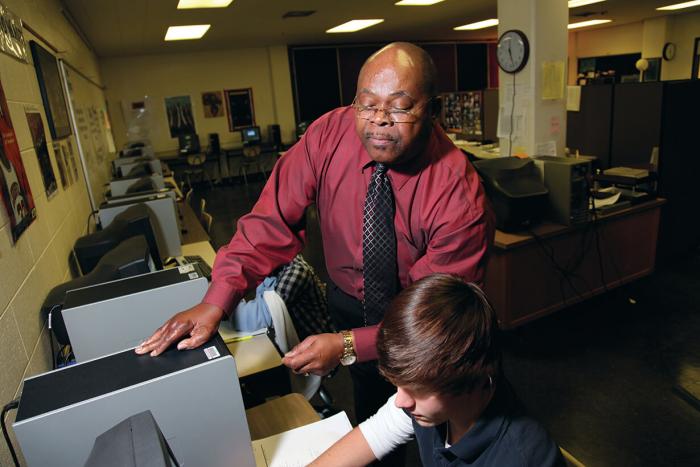 Louis Bryant helps a sophomore student