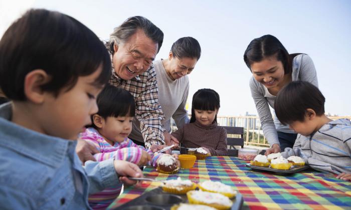 Family eating cupcakes on balcony