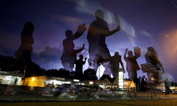 protesters march in Ferguson, MO after Michael Brown was fatally shot