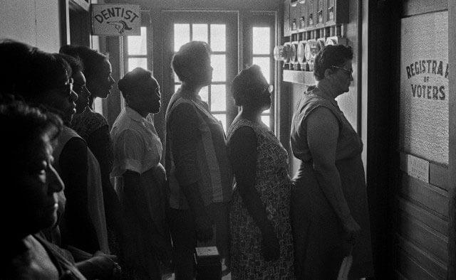 Multiracial ladies waiting in line to register to vote