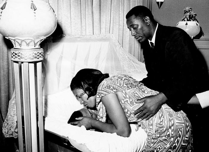 Medgar Evers' parents look over his dead body