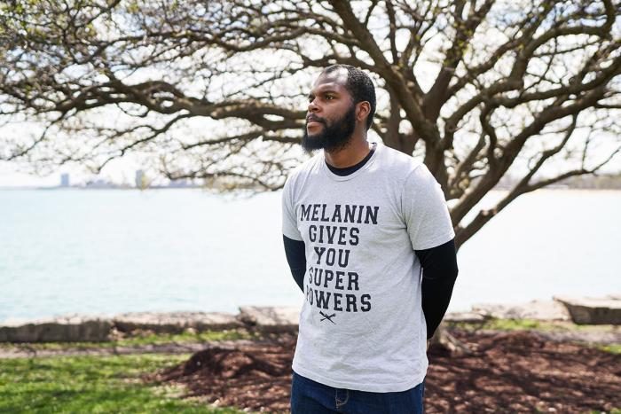 Educator Jordan Lanfair standing in front of a tree