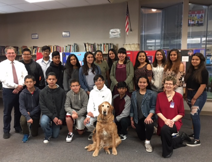 Group of students and teachers (and a dog) gathered together for a group photo.