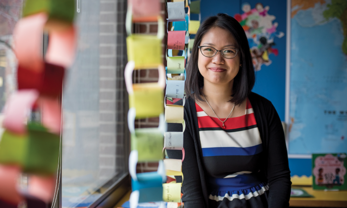 Kindergarten teacher Regina Santiago in her classroom surrounded by crafts.