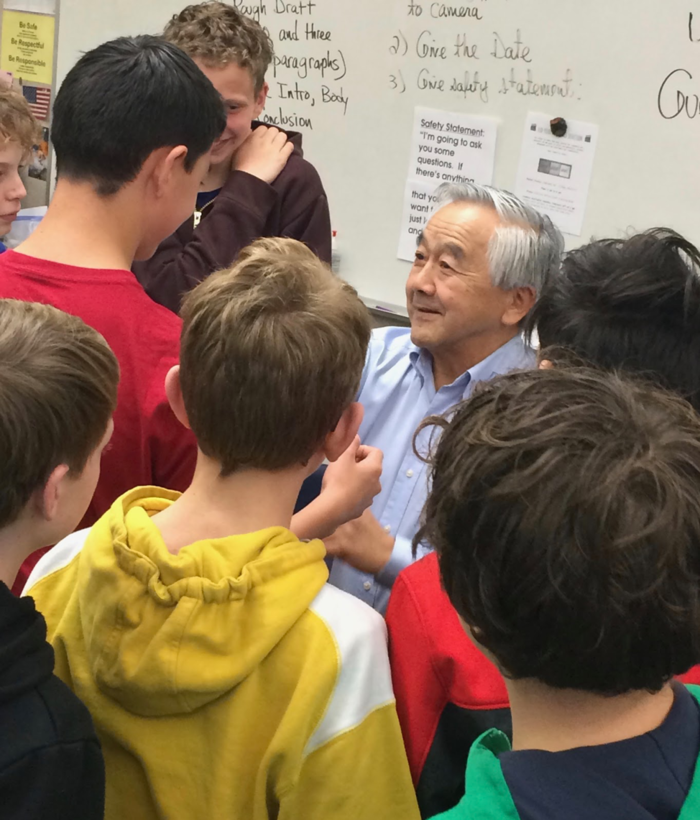 Several students in Santa Rosa classroom chatting with interviewee. 