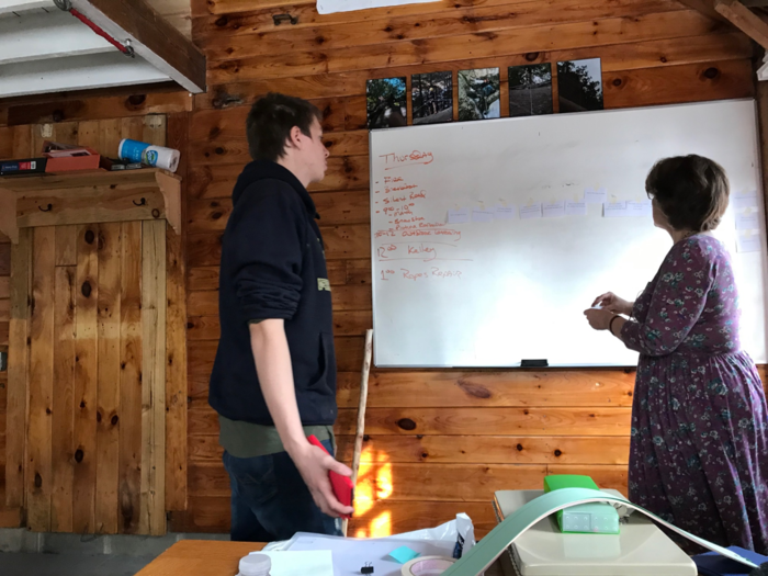 Outdoor Adventure students organizing a timeline of plot events in Tribal Journey by Gary Robinson (7th Generation, 2013).