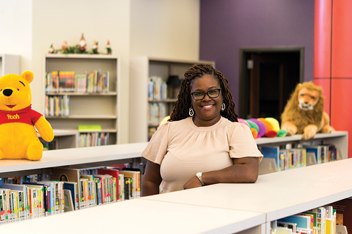 Educator Ayesha al-Shabazz surrounded by books.