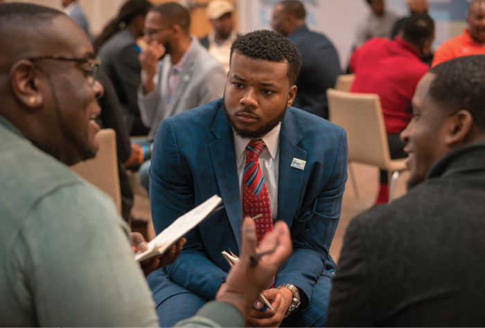 Three Black educators in discussion.