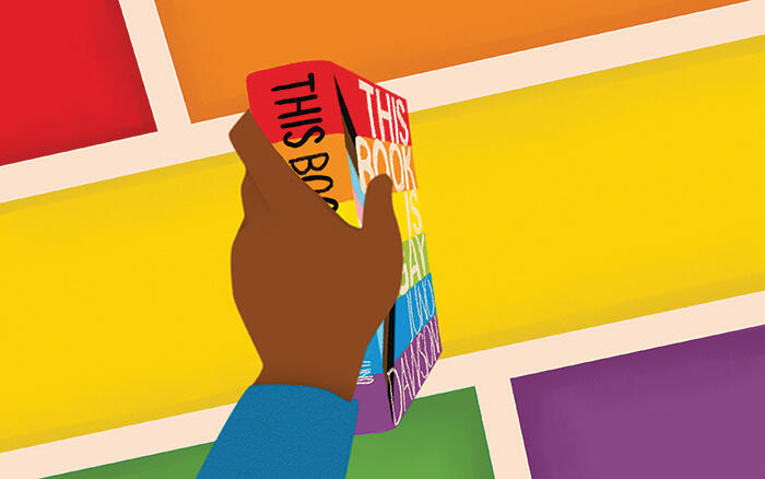 Illustration of a hand holding a book in front of a multi-colored shapes.