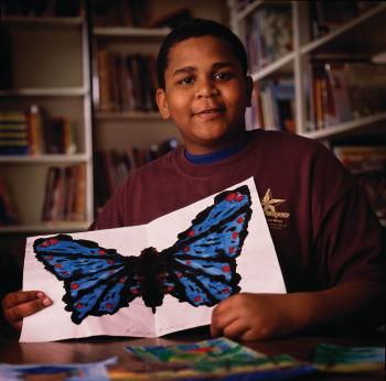 Kariem Ramee holding a butterfly drawing