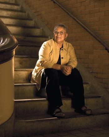 Minnijean Brown sitting at the school stairs