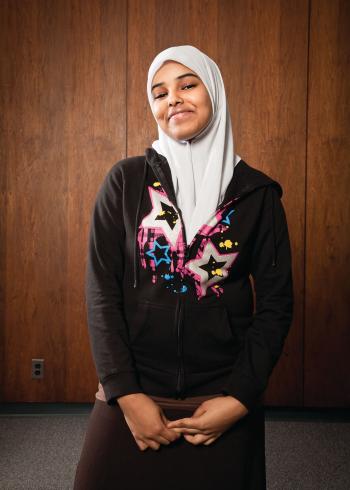A Muslim young woman with a hijab smiles