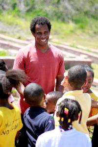 Smily Mark Bowen surround by children