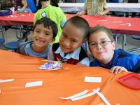 3 young students from different ethnicities smilling